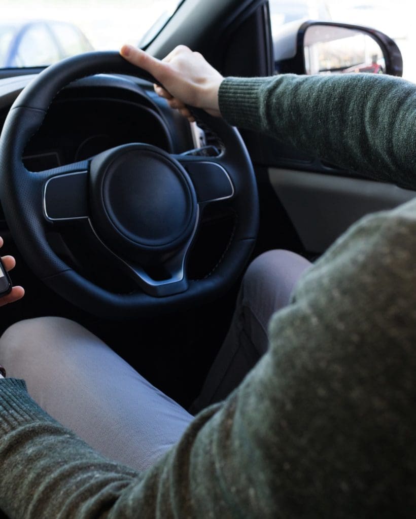 man-using-smartphone-while-driving-car.jpg